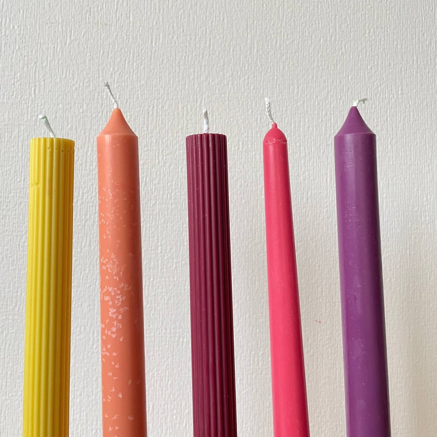 La Bouqe colorful taper candles for dinner table in yellow orange burgundy pink and purple