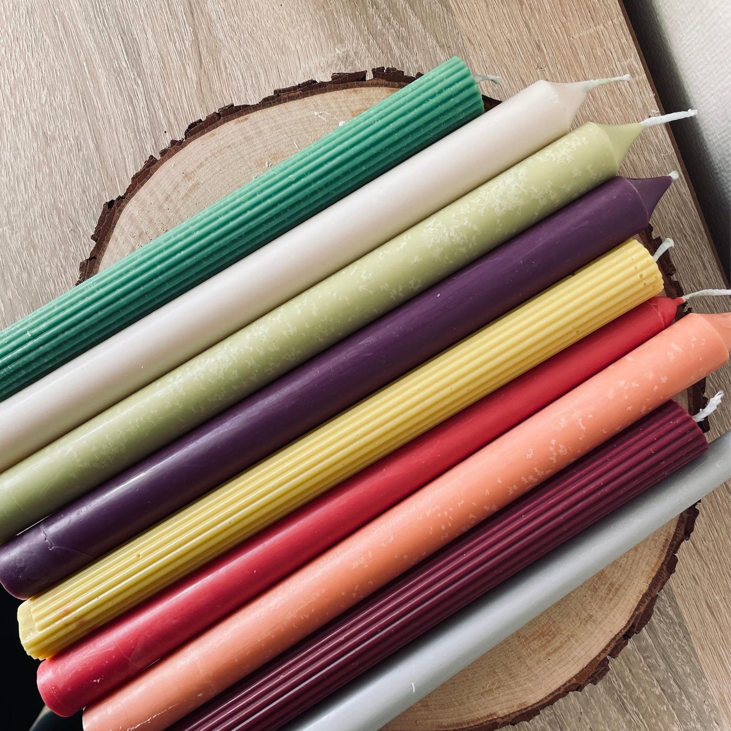 La Bouqe colorful taper candles for dinner table in various colors arranged on wooden surface