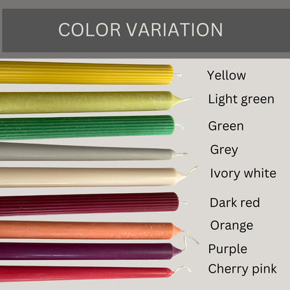 Colorful taper candles for dinner table in nine shades including yellow light green green grey ivory white dark red orange purple and cherry pink