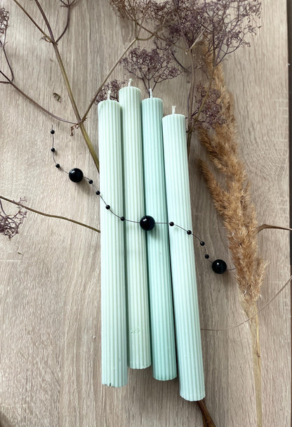 La Bouqe elegant dinner candles 4 pack in light pastel color with ribbed texture on wooden surface