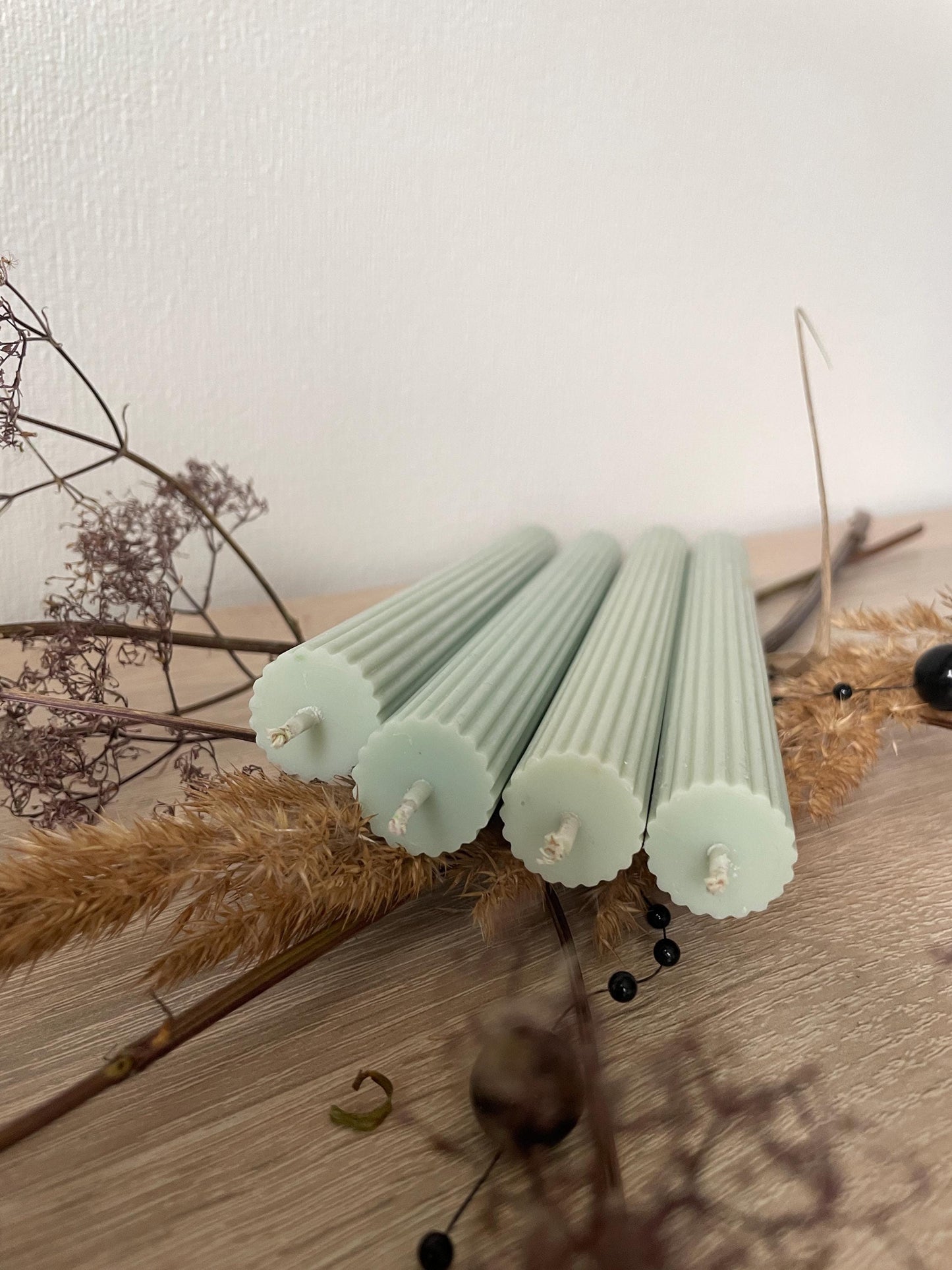 Long lasting soy candles 4 pack in light green with ribbed texture on wooden surface