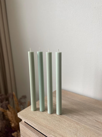 La Bouqe elegant dinner candles 4 pack in light green with ribbed texture on wooden surface