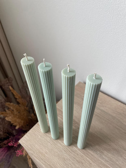 La Bouqe elegant dinner candles 4 pack in soft pastel green with ribbed texture on wooden surface