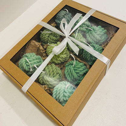 La Bouqe yarn ball soy candles in various green shades packed in a brown gift box with white ribbon