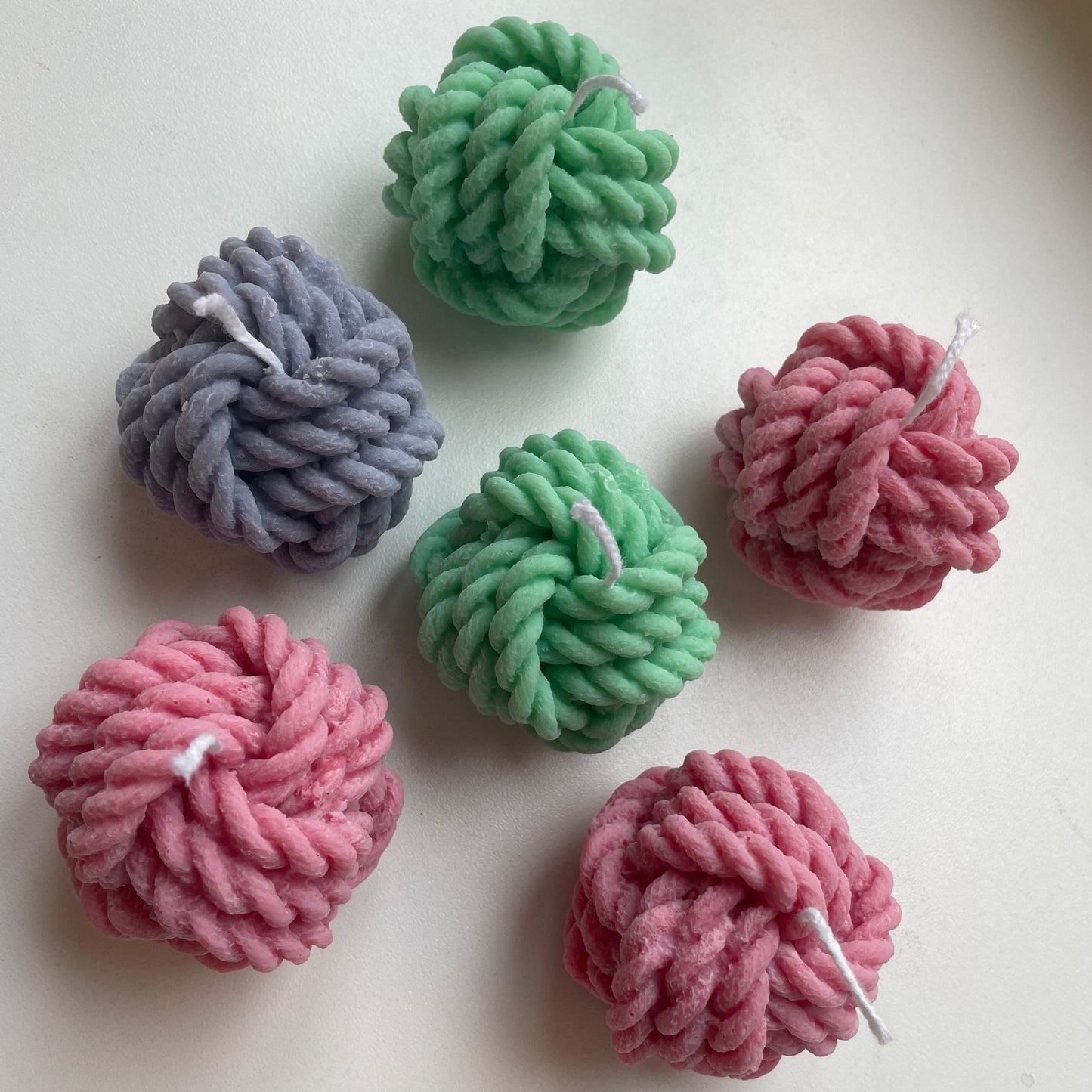La Bouqe colorful yarn ball soy candles in green pink and purple with twisted rope design